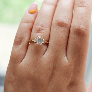 Emerald cut champagne diamond engagement ring on hand