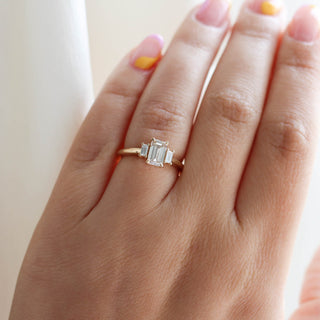 Emerald cut champagne diamond engagement ring on hand