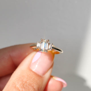 Emerald cut champagne diamond engagement ring in hand