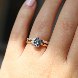 Claire White Lab Diamond Band paired with oval blue sapphire ring on hand in sunlight