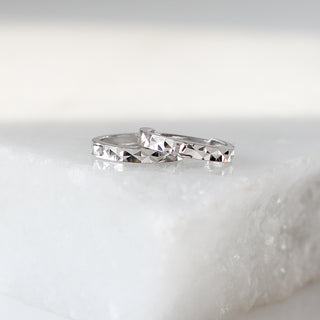 Clara Diamond Cut Hoops in white gold stacked side view on marble