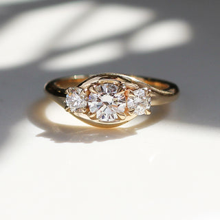 Yellow gold three stone engagement ring with natural diamonds