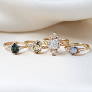 Four gold rings with different gemstones, ethically sourced and hand crafted at the Yuliya Chorna Jewellery studio in Toronto. 