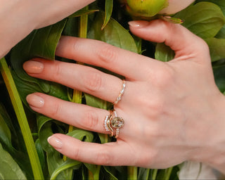 Close-up of hands with rings on a bouquet of flowers