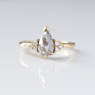 Custom engagement ring with ethically sourced teardrop diamond centre stone in a gold setting, handcrafted by Yuliya Chorna at her Toronto studio.