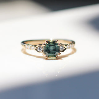Cut Corner Rectangle Step Cut Green Sapphire Ring front view in sunlight