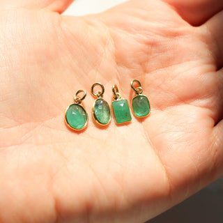 Green Charms in hand in sunlight front view 