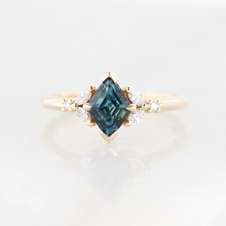 Yellow gold ring with a teal lozenge cut sapphire and white diamond accents, front view