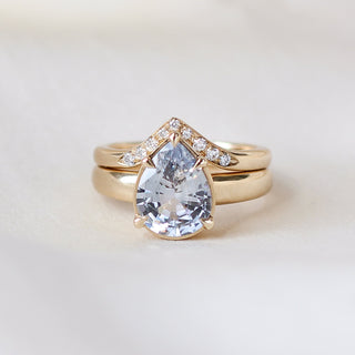 Pear pale blue sapphire engagement ring stacked with diamond gold band detail view