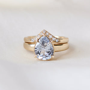 Pear pale blue sapphire engagement ring stacked with diamond gold band detail view