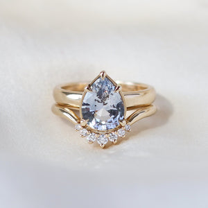 Pear pale blue sapphire engagement ring stacked with diamond gold band front view