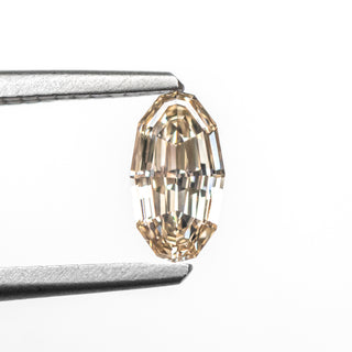 Geo oval step cut champagne diamond in tongs