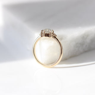 Shield cut icy salt and pepper diamond ring in yellow gold on marble profile view
