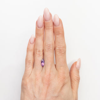 Hexagon cut purple pink sapphire on hand