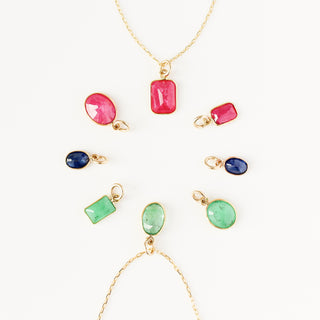 colourful gemstone charms in yellow gold