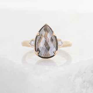 Custom engagement ring with ethically sourced teardrop centre stone in a gold setting, handcrafted by Yuliya Chorna at her Toronto studio.