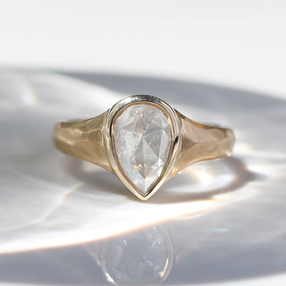 Custom teardrop engagement ring with ethically sourced diamond centre stone in a gold setting, handcrafted by Yuliya Chorna at her Toronto studio.