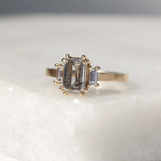Custom engagement ring with ethically sourced salt and pepper diamond centre stone in a gold setting, handcrafted by Yuliya Chorna at her Toronto studio.