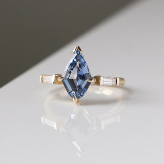Custom engagement ring with ethically sourced sapphire centre stone in a gold setting, handcrafted by Yuliya Chorna at her Toronto studio.