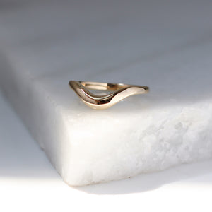 Large Wave Gold Wedding Band quarter view on marble