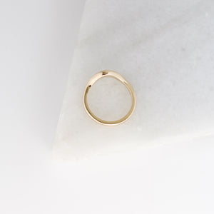 Large Wave Gold Wedding Band profile view on marble