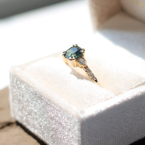 Square cut green sapphire ring in jewelery box
