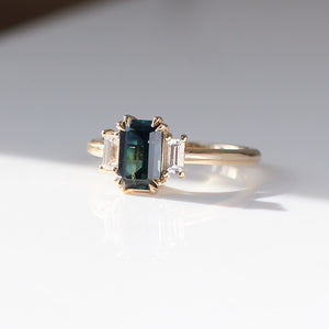 Emerald cut green sapphire engagement ring three quarter view