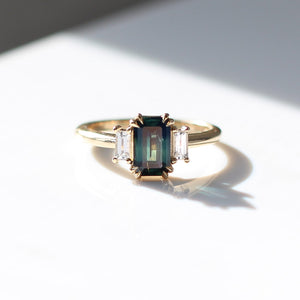 Emerald cut green sapphire engagement ring in sunlight