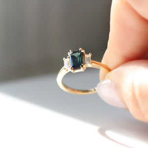 Emerald cut green sapphire engagement ring close up
