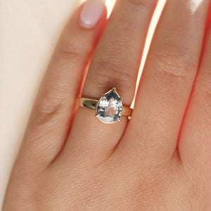 Pear pale blue sapphire engagement ring on hand