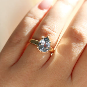 Pear pale blue sapphire engagement ring close up on hand