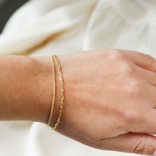 thin paper clip chain bracelet worn on hand with other chain bracelet