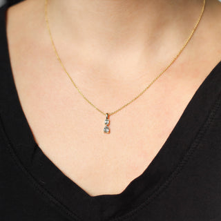 Emerald cut and pear diamond necklace worn