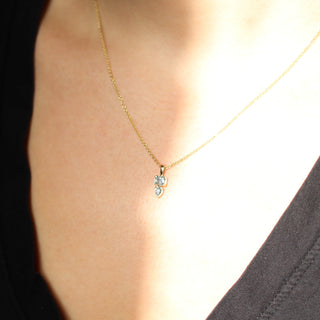 Emerald and pear cut diamond necklace worn