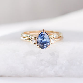 five diamond wedding band and pear blue sapphire ring set