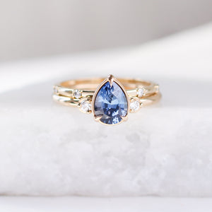 five diamond wedding band and pear blue sapphire ring set