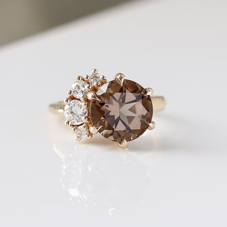 Custom circular cut ring with ethically sourced brown centre stone in a gold setting, handcrafted by Yuliya Chorna at her Toronto studio.