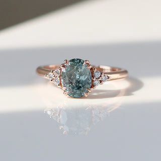 Custom engagement ring with ethically sourced oval sapphire in a gold setting, handcrafted by Yuliya Chorna at her Toronto studio.