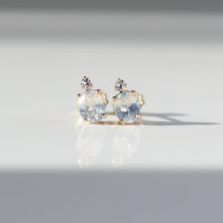 oval cut sapphire earrings accented by a tiny round cut sapphire in solid gold front detail view