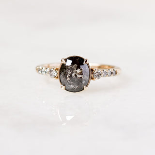 Custom engagement ring with ethically sourced oval centre stone in a gold diamond studded setting, handcrafted by Yuliya Chorna at her Toronto studio.