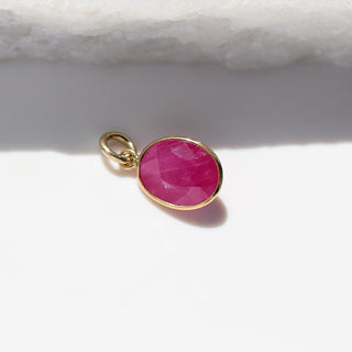 Large Ruby Bezel Charm in sunlight detailed side view