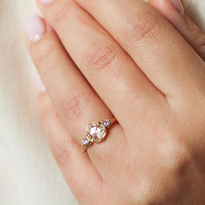 Round rose cut white diamond engagement ring close up on hand