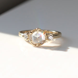 Round rose cut white diamond engagement ring in sunlight