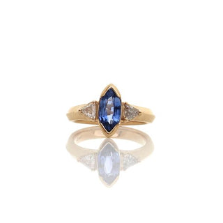 Custom engagement ring with ethically sourced marquise sapphire centre stone in a gold setting, handcrafted by Yuliya Chorna at her Toronto studio.