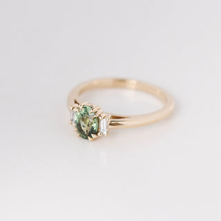 Yellow gold ring with a mint green oval cut sapphire, quarter view
