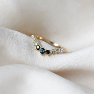 Custom mixed gem wedding band and in a gold setting, handcrafted by Yuliya Chorna at her Toronto studio.