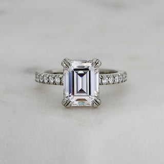 Custom moissanite emerald cut engagement ring with ethically sourced diamond centre stone in a platinum setting.