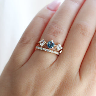 Blue Cushion Cut Montana Sapphire Three Stone Ring paired with diamond gold band being worn