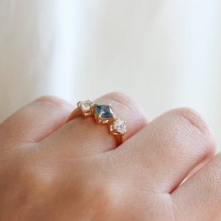 Blue Cushion Cut Montana Sapphire Three Stone Ring being worn side view 