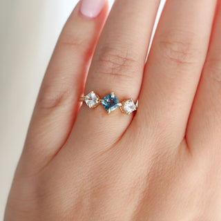 Blue Cushion Cut Montana Sapphire Three Stone Ring worn on hand detailed front view